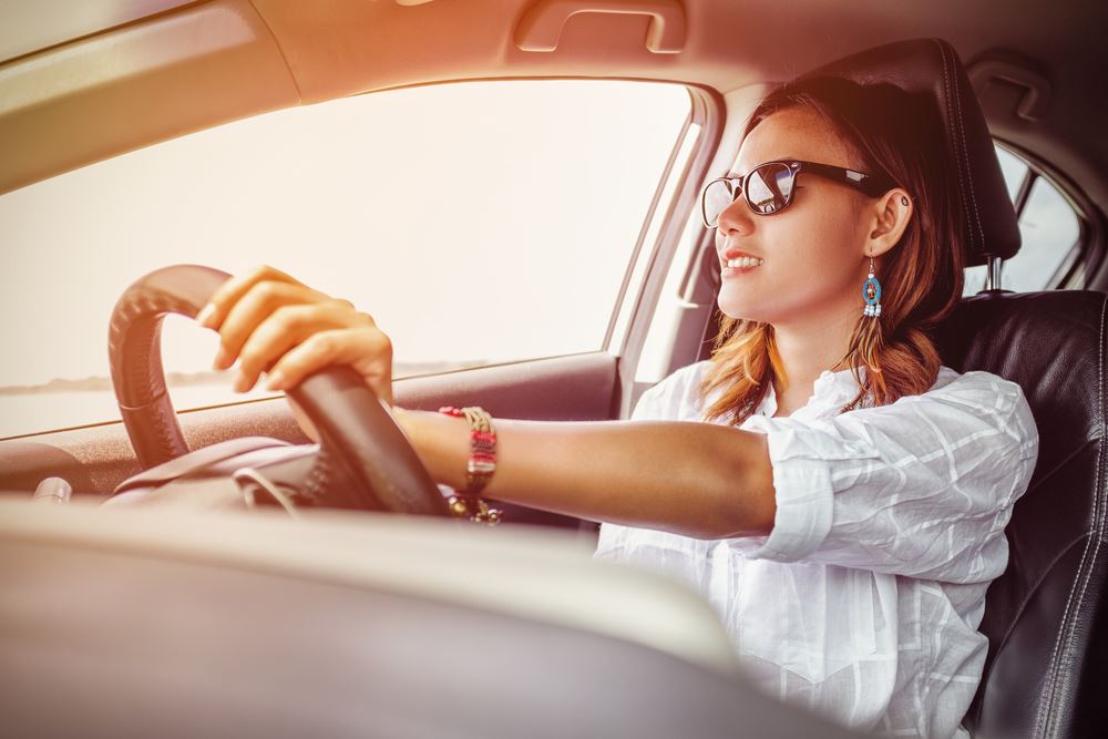 Woman with sunglasses driving